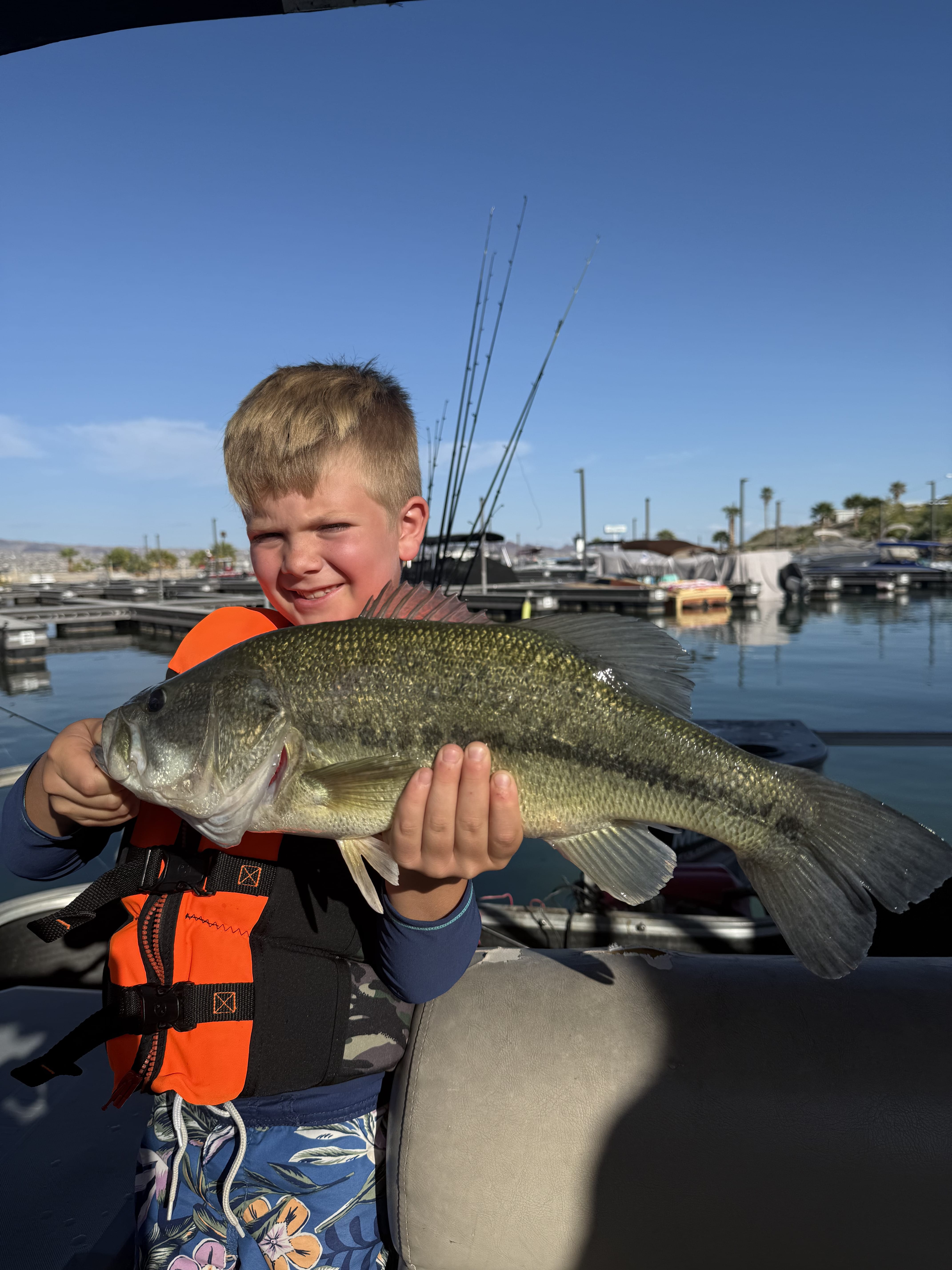 Youth angler holding a largemouth bass at the marina