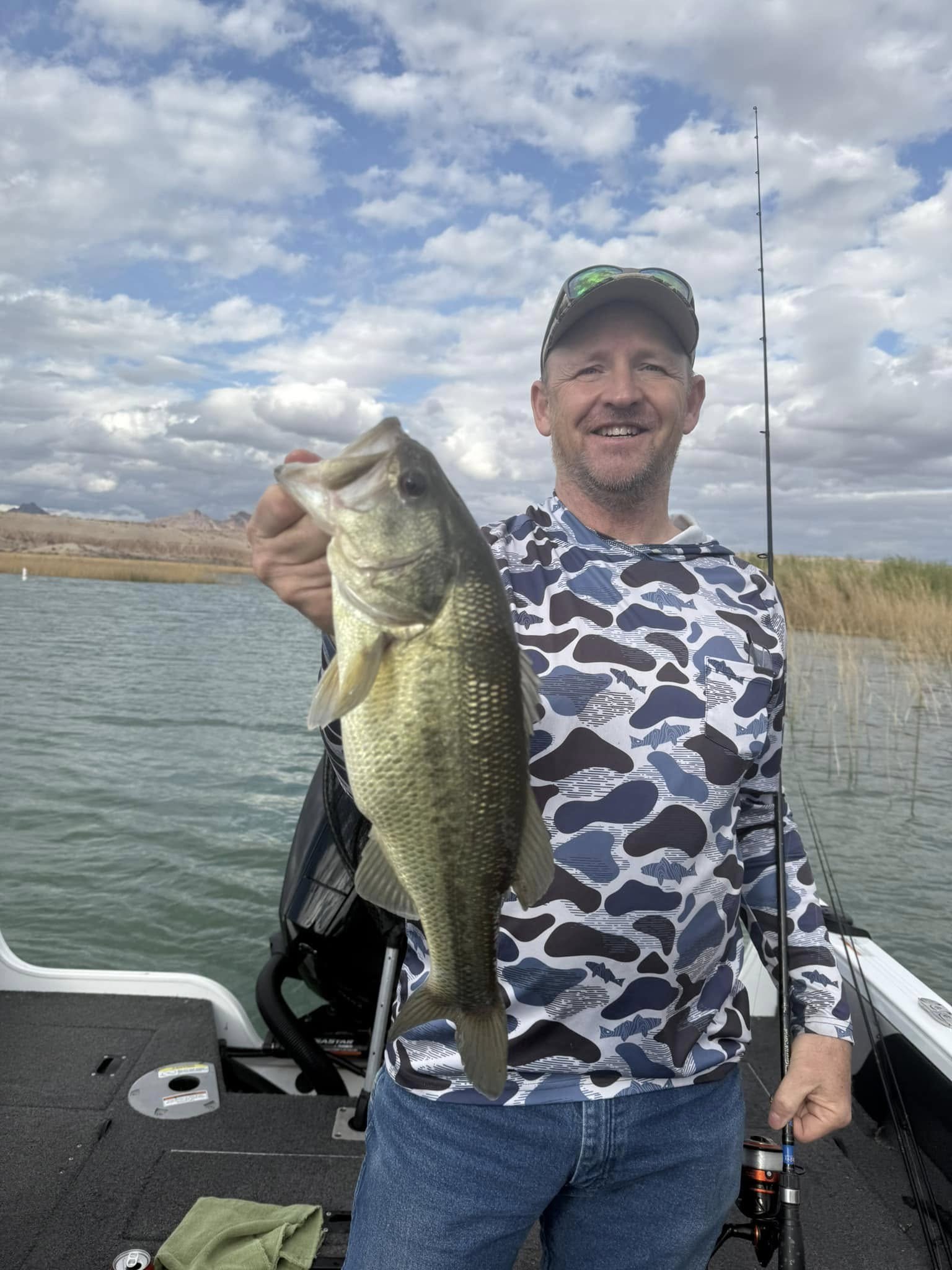 Angler holding a largemouth bass on Lake Havasu